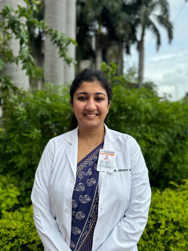 Dr. Nishita in white coat